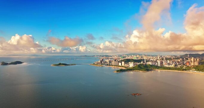 Panoramic aerial view of Macao and Zhuhai coastal cityscape with bridge and islands, China
