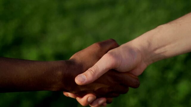 Diversity and multiethnic hands stacking together for anti racism concept during global unity celebration event in 4K Ultra HD footage.
