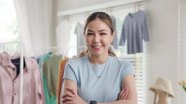 Young adult asia woman people smile look at camera work happy old used heap shirt sale online second hand sell thrift store. Go green eco fabric reduce zero waste issue side hustle small home shop.