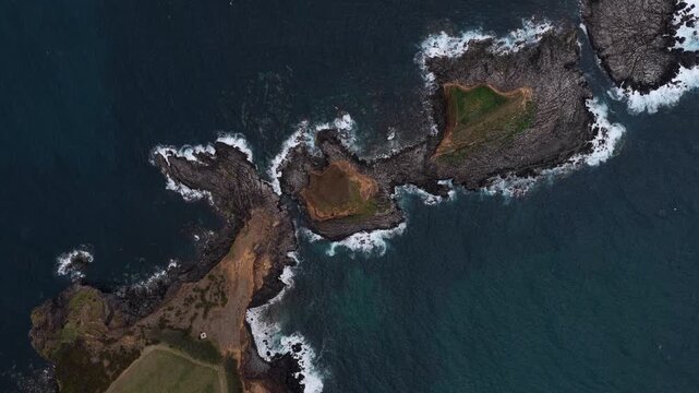 Aerial view of the rocky coastline and islets surrounding Forte da Greta in Vila de Sao Sebastiao, Azores, Portugal.