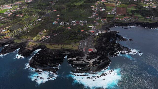 Aerial view of the volcanic rock coastline and natural swimming pools of Biscoitos, Azores, Portugal.