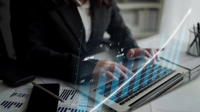 A business professional is engaged in financial data analysis on a laptop, showcasing digital graphics that highlight stock market trends and performance metrics. Copula