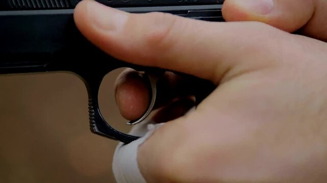 Gun in a hand of tactical security officer during professional defense training operation for public safety concept in 4K Ultra HD footage.

