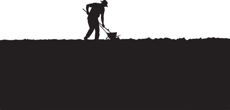 Silhouette of a man plowing soil with a rototiller