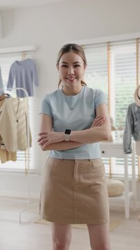 Young adult asia woman people smile look at camera work happy old used heap shirt sale online second hand sell thrift store. Go green eco fabric reduce zero waste issue side hustle small home shop.