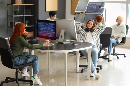 Team of young programmers working in office