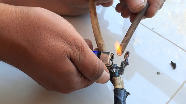 Technician connecting electrical wires for outlet using pliers and hot glue gun. Wiring installation and insulation process. Electrician stock video 4K for DIY, renovation, safety, construction, maint