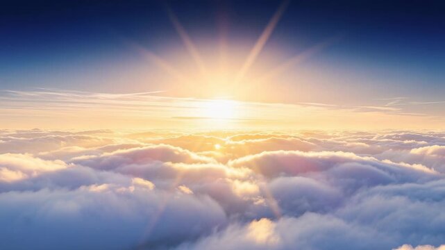 Beautiful sunrise above fluffy clouds with warm sunlight and clear blue sky