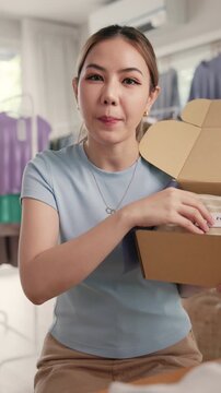 POV Gen Z vlogger SME owner go green zero waste thrift store sale live stream talk on social media online second hand sell. Asia people young woman record home AI video camera app eco shop side hustle