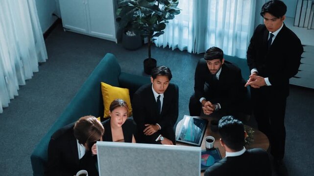 Top view of smart business team looking financial statistic while executive manager raise hand and point at marketing data on whiteboard. Happy diverse group brainstorm creative idea. Directorate.