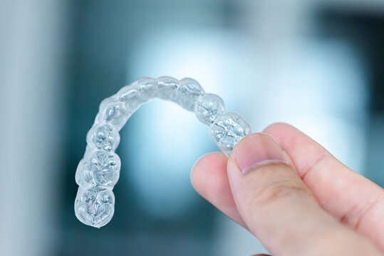  clear aligners device in the mouth on a white background. (invisalign)