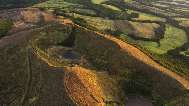 Aerial view of Sete Cidades volcanic crater with lush green hills and crater lakes in Sete Cidades, Azores, Portugal.