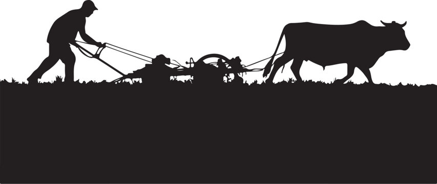 Silhouette of a man plowing a field with a cow