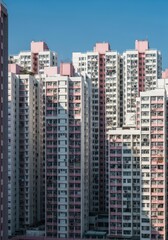 Naklejka premium High-Density Residential Apartment Buildings with Pink and White Facades in Hong Kong Cityscape