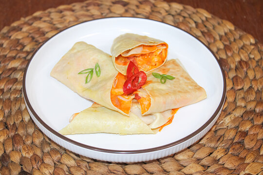 Spicy indonesian traditional kebab or martabak pieces served on white plate
