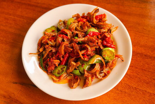 Tumis Teri Pete or Stir-fried Anchovies with Stink Beans. It's a bold and aromatic side dish or accompaniment, embodying the strong flavors of authentic Indonesian cooking.