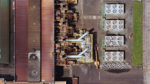Aerial view of the Tecnovia Acores industrial facility with cooling units and metal pipes in Rabo de Peixe, Acores, Portugal.
