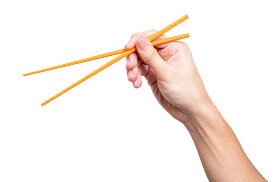 Male hand holding a orange plastic chopstick isolated on white background with a clipping path.	