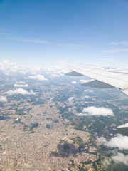 Naklejka premium View from an airplane window looking out over beautiful clouds and blue sky during flight.