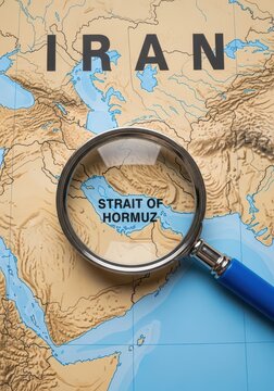 Magnifying Glass Focusing on the Strait of Hormuz on a Map of Iran and the Middle East Region