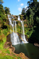 Obraz premium Tad Gneuang is the beautiful waterfall with a rainbow surrounded by rain forest in Southern Laos