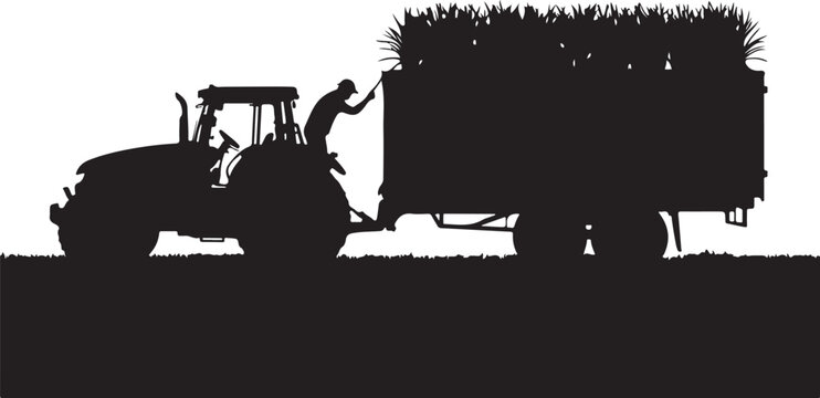 Silhouette of a tractor and trailer loaded with hay