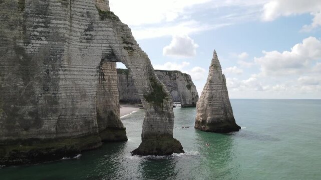 Aerial view of the iconic Falaises d'Etretat chalk cliffs and natural arch rising above the English Channel in Etretat, Normandy, France.