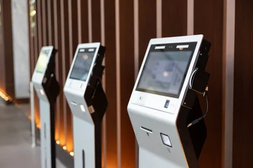 Fotobehang Minecraft Rows of touch-screen kiosks in polished lobby. self check for hotel concept.  © Rattanachat