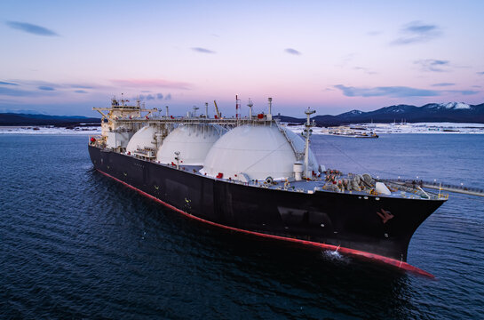 Aerial of Liquified Natural Gas LNG carrier moored to a small gas terminal. Fuel crisis. Sanctions