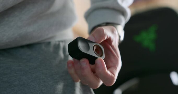 A Man Gets The Insta360 GO 3 Ultra-lightweight Action Camera In His Trousers Pocket. Close-up Shot