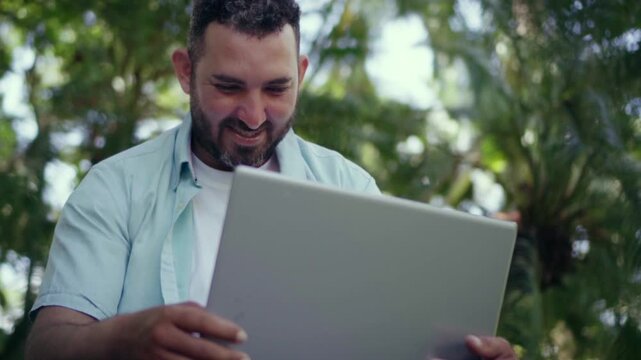 Freelancer working outdoors with laptop computer