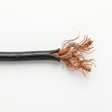 Frayed wire isolated on white background with exposed copper strands  