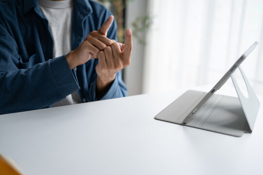 Close up of man using sign language for ASL for accessible online learning and virtual communication.