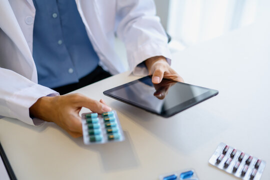 Pharmacist using digital tablet and AI system for medication management using technology and AI innovation healthcare and smart pharmacy.