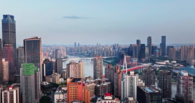 Aerial view of dense urban residential buildings and bridges over the Jialing River in Chongqing, China.