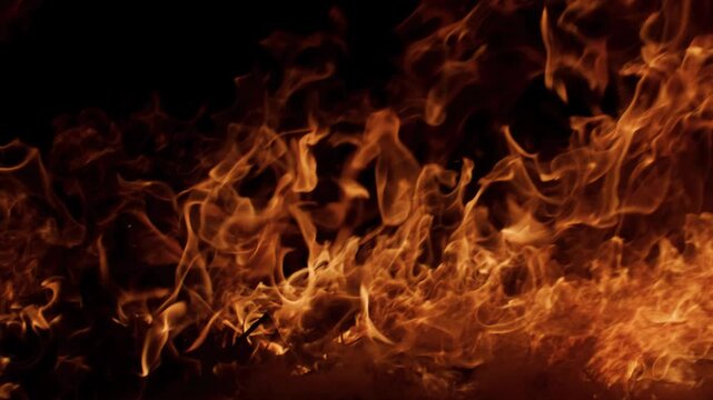 Fire blazing aggressive flames. Fire burning cinematic inferno. Fire glowing intense highlights. Fire motion background loop.