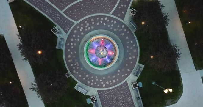 Aerial drone video looking straight down onto a colorful water fontain Lake Geneva, Wisconsin.