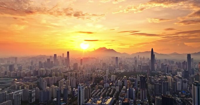 Stunning golden sunrise over the dense urban skyline and skyscrapers of Shenzhen, China