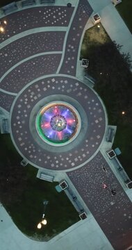 Aerial drone video looking straight down at a colorful water fountain and rotating in Lake Geneva, Wisconsin.