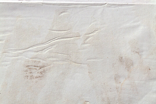 Vintage distressed white paper sheet with fold lines and texture overlay for graphic design.