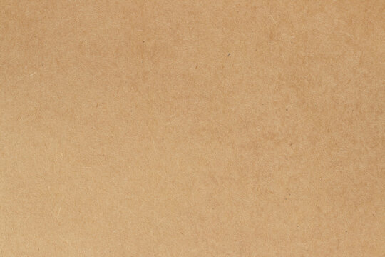 Brown cardboard sheet abstract background, texture of sepia color kraft paper with vintage pattern for design art work.