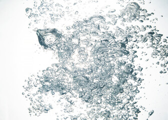 Fototapeta premium Splashing water, oxygen relaxation. air bubbles float up in clear water. pure drinking water, clean and clear water textured on white background