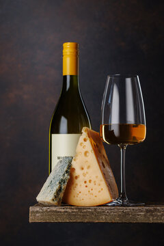 White wine glass with cheese on rustic table