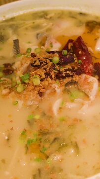 Spicy Sichuan Fish Soup with Chili Peppers in White Bowl