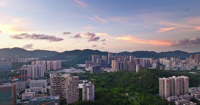 Aerial view of modern residential district and mountain landscape with a traditional pagoda at sunset in Shenzhen, China