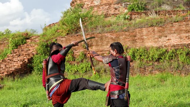 Thai Martial Arts Sword Fight Between Warriors in Ancient Ruins