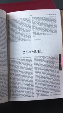 Opening to the Book of 2 Samuel of the Old Testament in the Holy Bible. New Revised Standard Version. Vertical video.