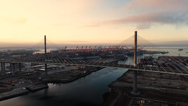 A soaring sweep of the Gateway Bridge in Long Beach reveals the massive Port of Los Angeles on a cold cloudy morning in spring