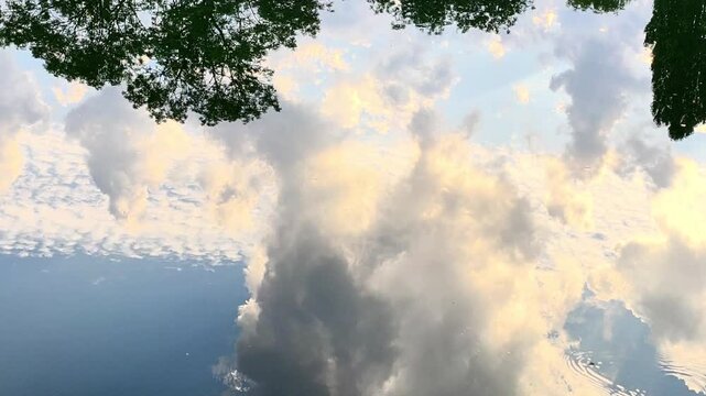 Golden Clouds Reflecting in Calm River Water