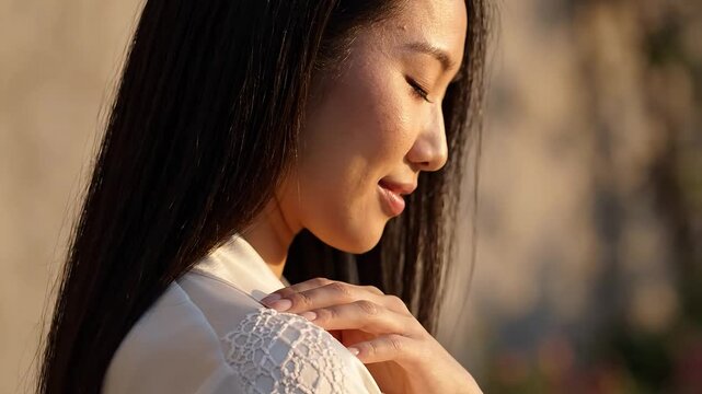 A serene close-up of a woman enjoying a peaceful moment outdoors.